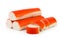 Three crab sticks and cut into pieces on a white background. Isolated