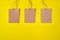 Three Craft brown paper tags isolated on yellow background. Sale price banner with copy space in minimal style