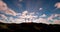 Three crosses on the hill with clouds moving on blue starry sky