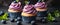 Three Cupcakes With Blueberry Icing and Mint Leaves