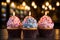 three cupcakes with lit candles on a wooden table