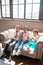 Three curly-haired kids sitting on the sofa and sending air kisses