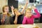 Three cute funny siblings eating slices of pizza at indoor restaurant or cafe