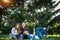 Three cute girlfriends resting the park. Young attractive girls on a green lawn talking and laughing. Concept of outdoor