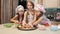 Three cute girls take a cookie from the plate