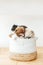 Three cute pomeranians puppies lying in a basket on wooden table