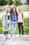 Three cute school girls heading off to school