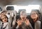 Three cute sisters of different ages are riding in the back seat of a car. Traveling by automobile with three children