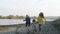 Three cute sisters running by the river.