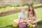 Three cute smiling kids collecting eggs on an Easter Egg hunt outdoors