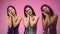 Three cute women showing sleep gesture, sweet dreams isolated on pink background