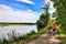 Three cyclists enjoy a summer day with a ride on a forested trail passing by a peaceful river in Wisconsin.