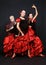 Three dancers in spanish dresses