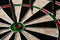 Three darts hit the dartboard. Lucky - one of the darts hits the bull& x27;s eye. The concept of winning and luck. Close