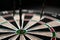 Three darts hit the dartboard. Lucky - one of the darts hits the bull& x27;s eye. The concept of winning and luck. Close