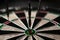 Three darts hit the dartboard. Lucky - one of the darts hits the bull& x27;s eye. The concept of winning and luck. Close