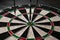 Three darts hit the dartboard. Lucky - one of the darts hits the bull& x27;s eye. The concept of winning and luck. Close
