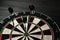 Three darts hit the dartboard. Lucky - one of the darts hits the bull& x27;s eye. The concept of winning and luck. Close