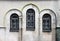 Three decorated windows with bars of orthodox church wall