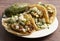 Three Delicious Buche Street Tacos in a Row on a Wooden Table