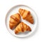 three delicious french croissants on a white plate