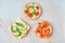 three delicious open sandwiches with salmon, tomatoes, cucumber