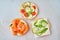 three delicious open sandwiches with salmon, tomatoes, cucumber
