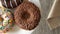 Three delicious sweet donuts rotating on a plate. Rustic wooden table. Looped. 00261