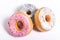 Three delicious and tempting donuts with different flavour donuts and toppings sugar sweet addiction concept