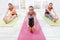 Three delighted girls enjoying their morning stretching.