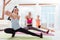 Three delighted women doing fitness exercises together