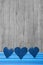 Three denim hearts on wooden shabby background