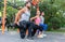 Three determined friends doing stretching exercises for legs as