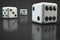 Three dice on a dark table. Close-up