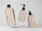 Three different beige glass bottles for hair and body care products 3D render, set of floating cosmetic containers on