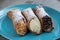 Three different delicious typical Sicilian cannoli filled with ricotta chse cream