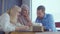 Three different ethnic friends man and women are chatting in cafe in daytime