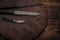 Three different rusty vintage knives on a round old wood cutting board