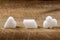 Three different sugar cubes on wood