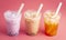 Three Different Types of Boba Tea on a Bright Pink Background