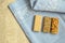 Three different types of gozinaki bars with sunflower seeds, peanuts and sesame seeds on a blue tablecloth background with embroid