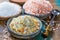 Three different types of natural salt in stone bowls on wooden s