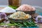 Three different types of natural salt in stone bowls on wooden s