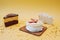 Three different types of sweets cakes on a yellow background with gold sequins