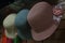 Three differently colored panama hats with roses on the sides on display in a small store in South America