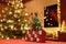 Three-dimensional Advent Calendar with stylised Christmas Tree in the middle of Christmassy decorated Family Room