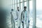 Three disinfectors or doctors walk in protective uniform walking in hospital corridor. Scientists in biohazmat suits walking along