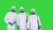 Three disinfectors walk in holding the disinfectant in their hands on a Green Screen, Chroma Key.