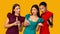 Three Dissatisfied Girls Holding Phones Reading Messages Over Yellow Background