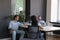 Three diverse office employees joking talking during break at workplace